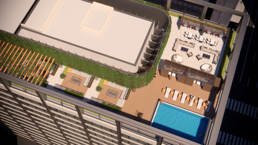 A top-down view of a pool area with lounge chairs and a green lawn.