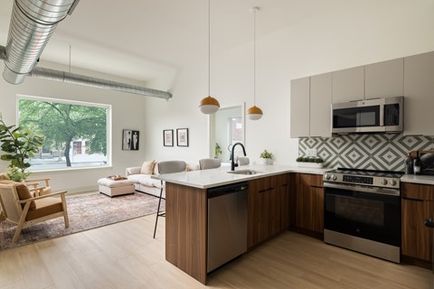 A modern kitchen with wooden cabinets and a large island.