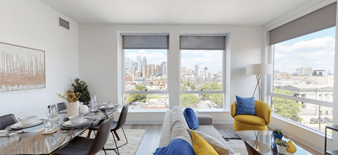 a living room with a table and chairs and a view of the city