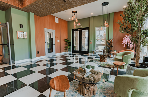 A room with a black and white checkered floor and green walls.