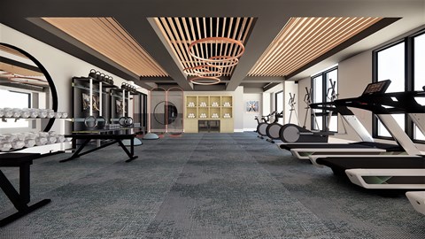 A gym with a variety of equipment including treadmills, weights, and exercise machines.