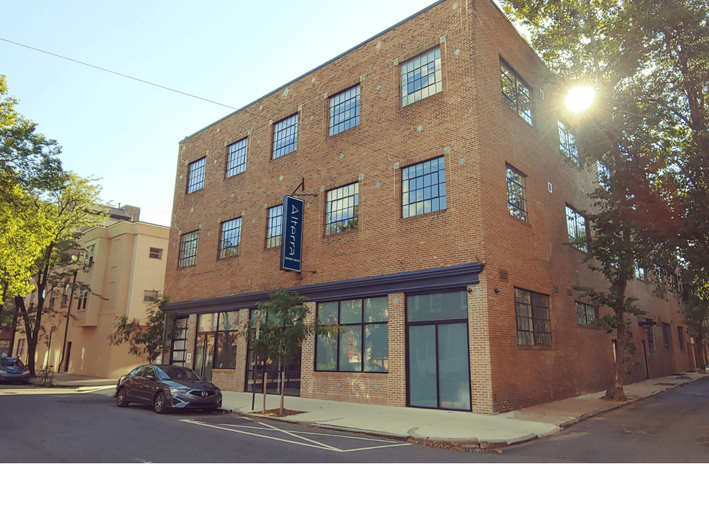 a brick building on a city street with a car