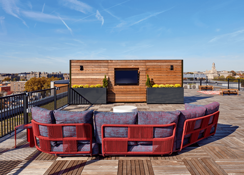 a lounge area with a couch and a tv on a wooden roof