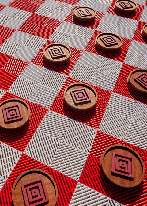 a close up of wooden buttons on a red and white table
