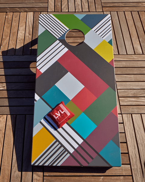 a rug with a color palette of different colors on a wooden deck