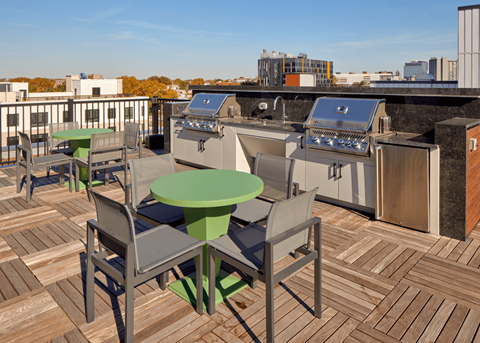 a rooftop terrace with tables and appliances on a roof