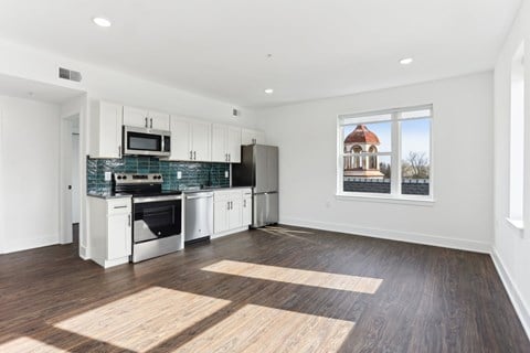 A kitchen with a black and white color scheme and a large window.