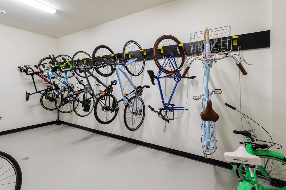 a wall mounted bike rack with several bikes on it
