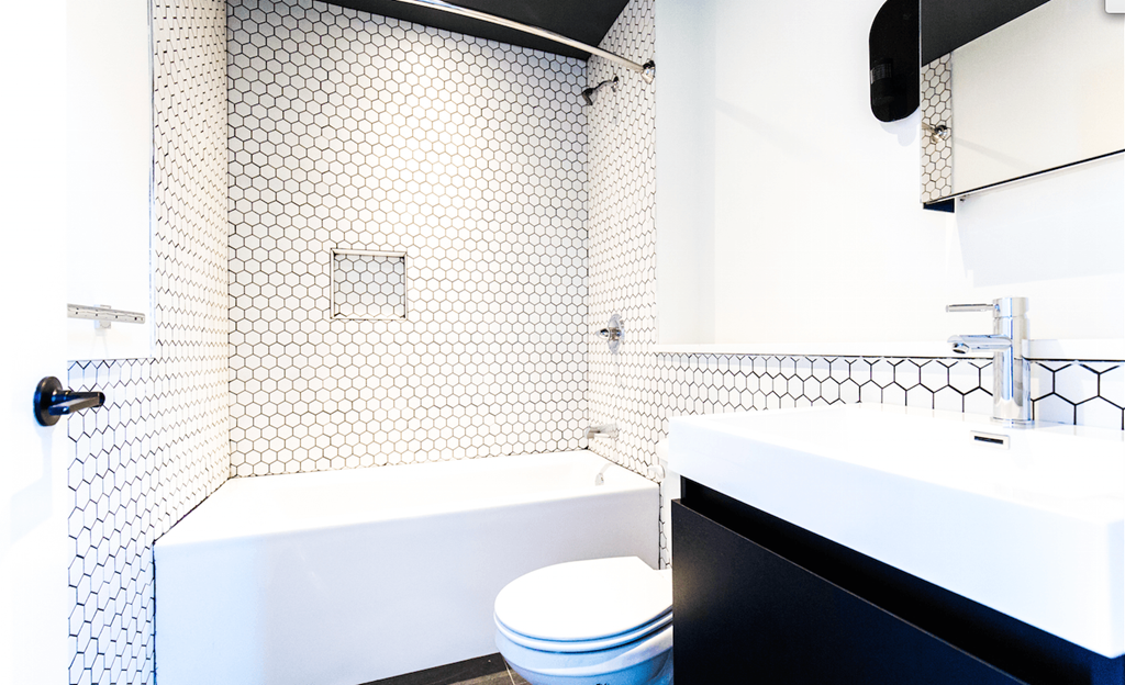a white bathroom with a toilet and a sink