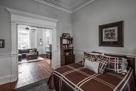 A bedroom with a large bed and a window.