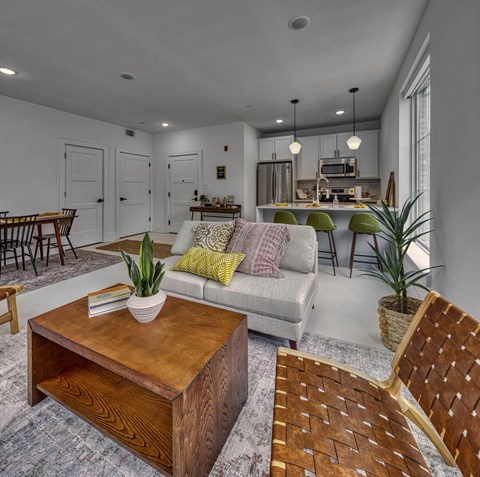 A modern living room with a wooden coffee table and a grey sofa.