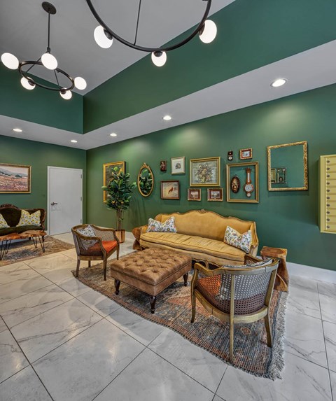 A living room with a green wall and a brown sofa.