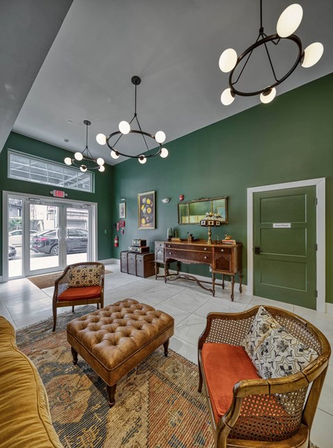 A room with a green wall and a wooden chair.