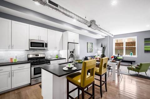A modern kitchen with a dining table and chairs.