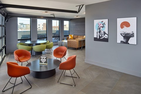 A modern dining room with a round table and chairs.