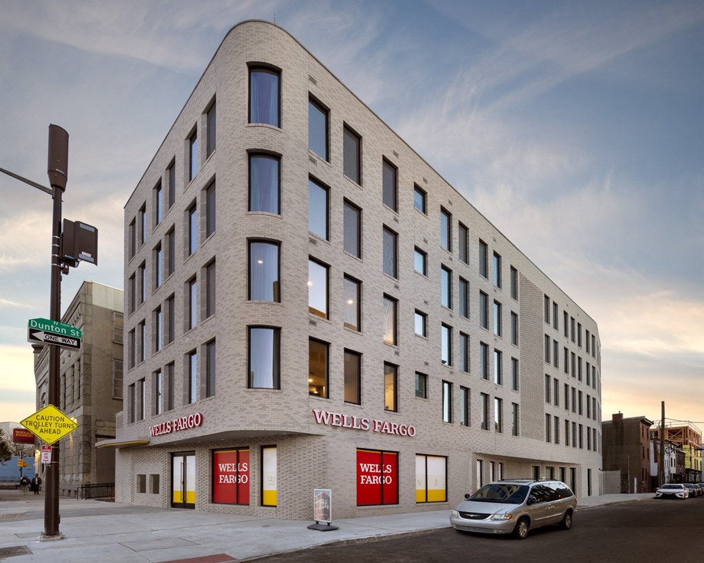 a large white building with a car parked in front of it