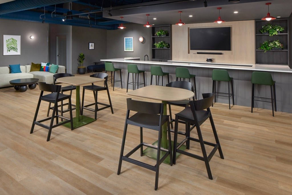 A room with a bar and chairs.