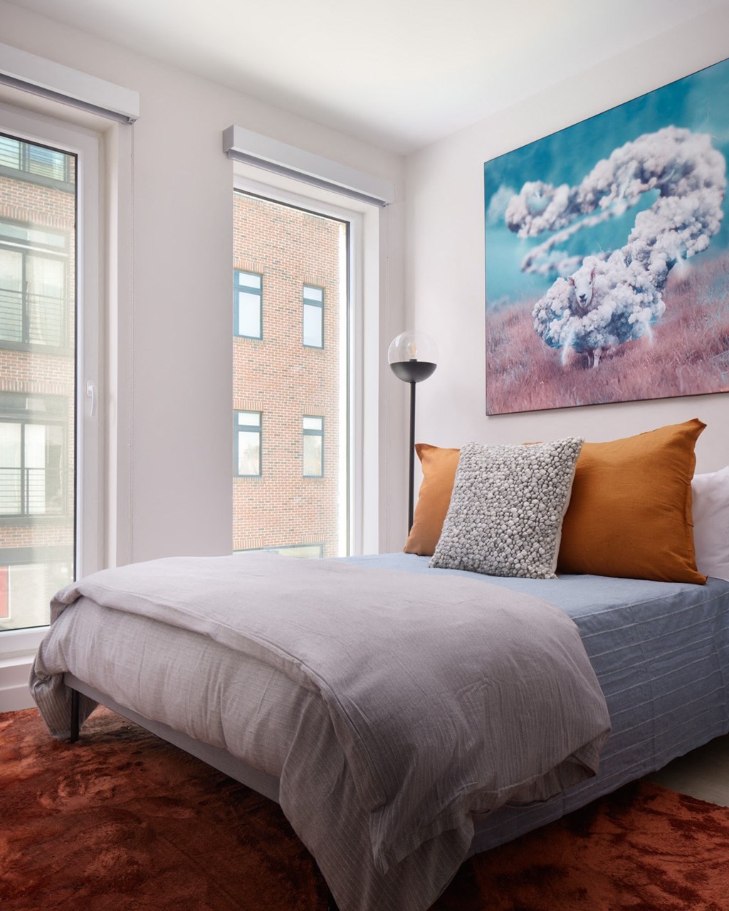 a bedroom with a bed and two windows