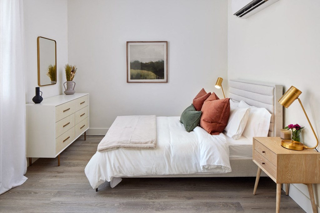 a bedroom with a bed and a dresser