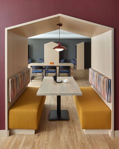 a dining room with yellow chairs and a table
