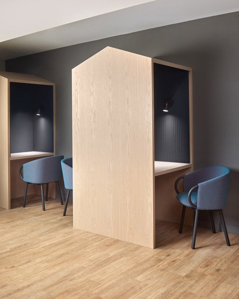 a room with blue chairs and a wooden partition