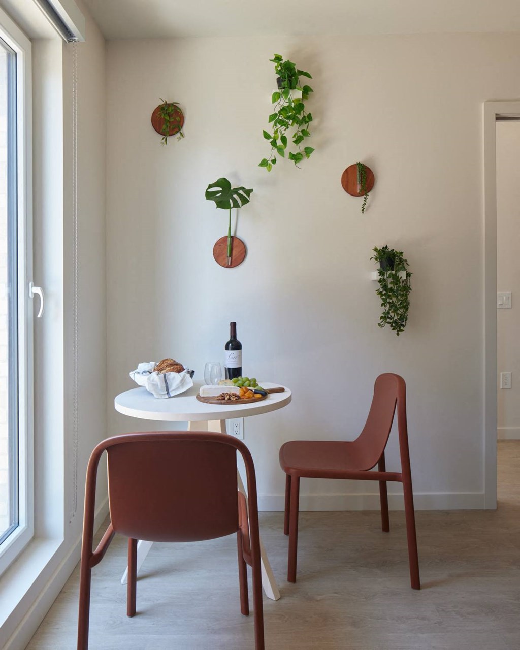 a small table with two chairs and a bottle of wine