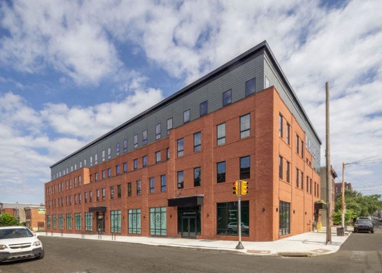 a large brick building on the corner of a street