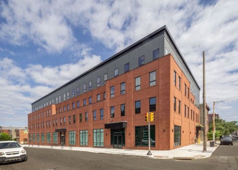 a large brick building on the corner of a street