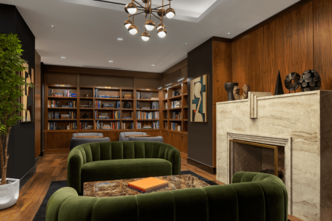 A living room with a fireplace and a bookshelf.
