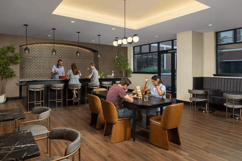 A group of people are sitting around a table in a modern restaurant.