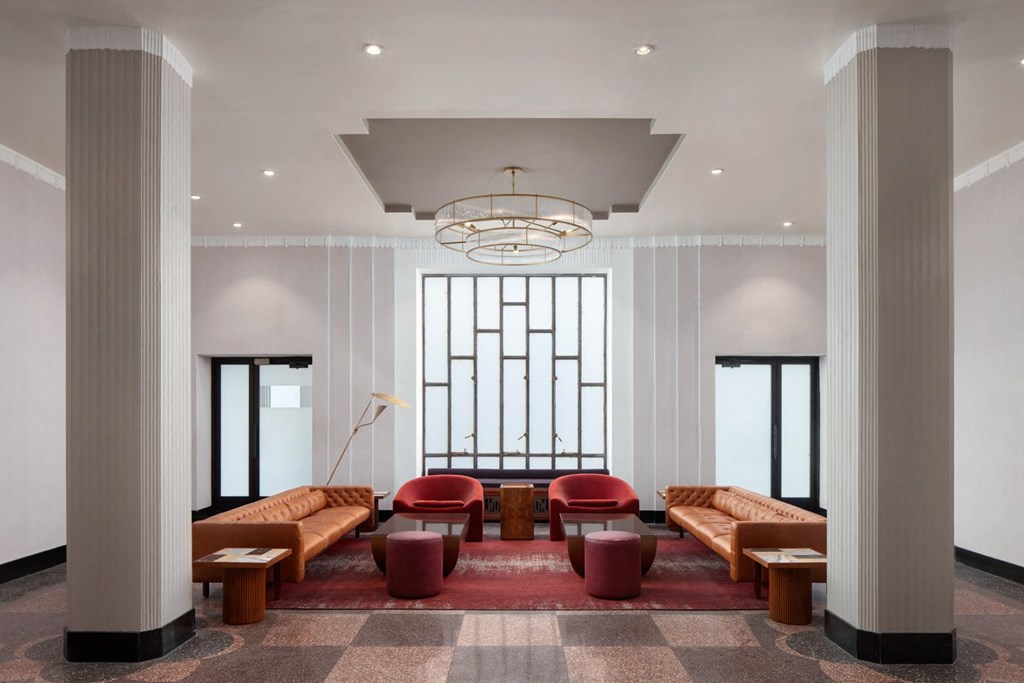 A large room with a long table and chairs in the middle.