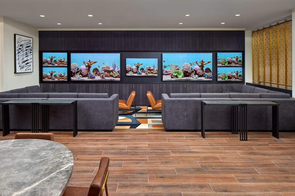 A modern living room with a grey sofa and a coffee table.