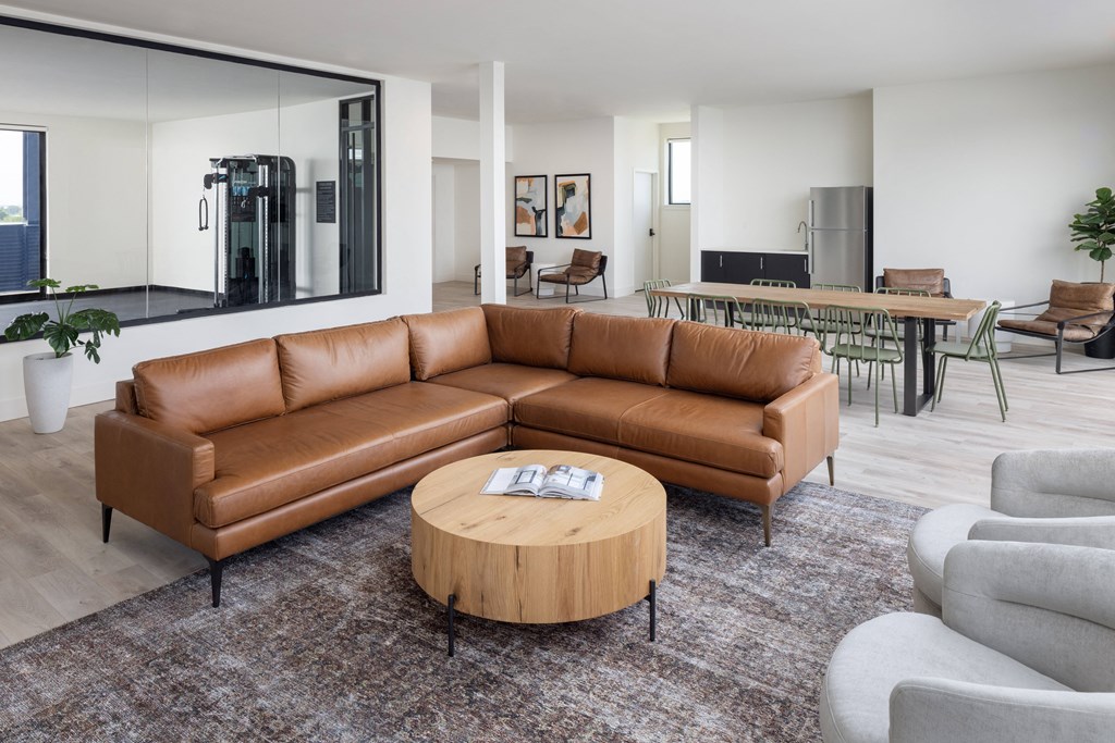 a living room filled with furniture and a large window