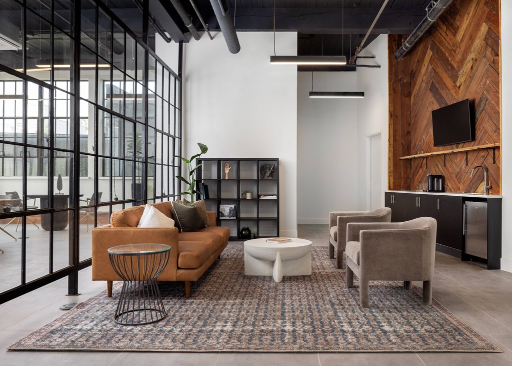 a living room filled with furniture and a large window