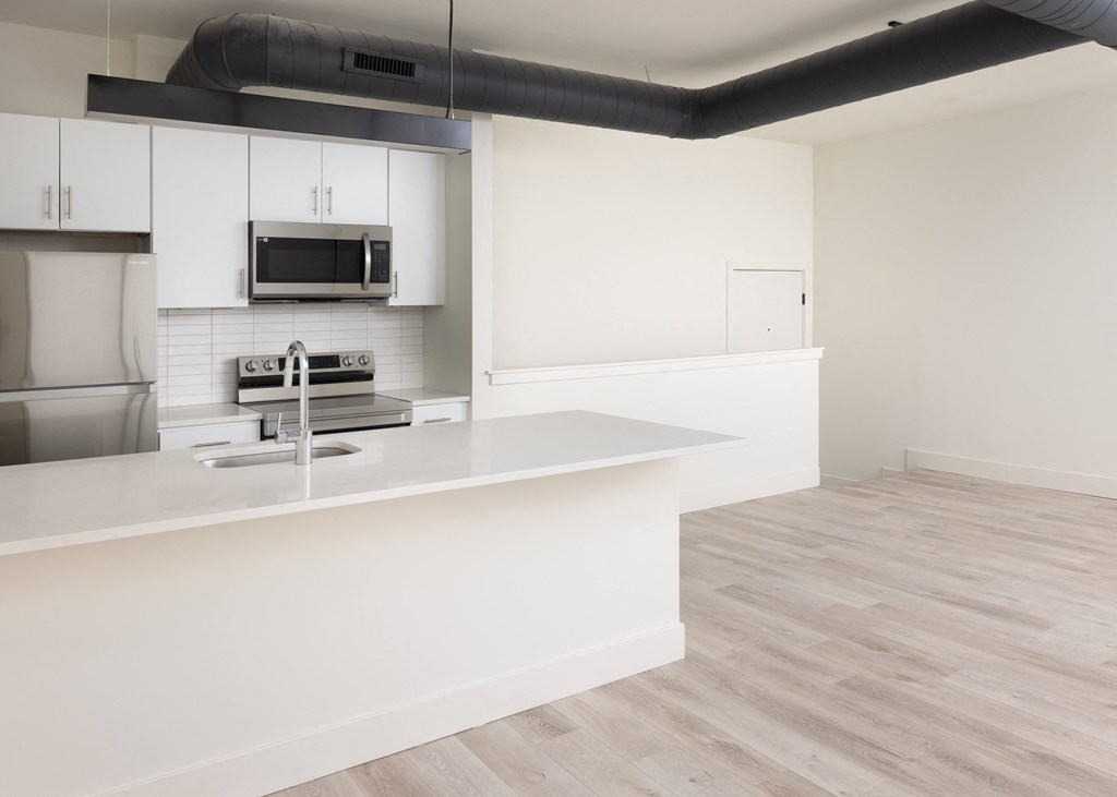 a kitchen and living room in a 555 waverly unit