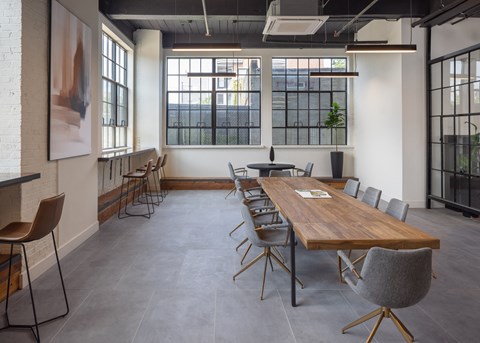a large room with a long wooden table and chairs