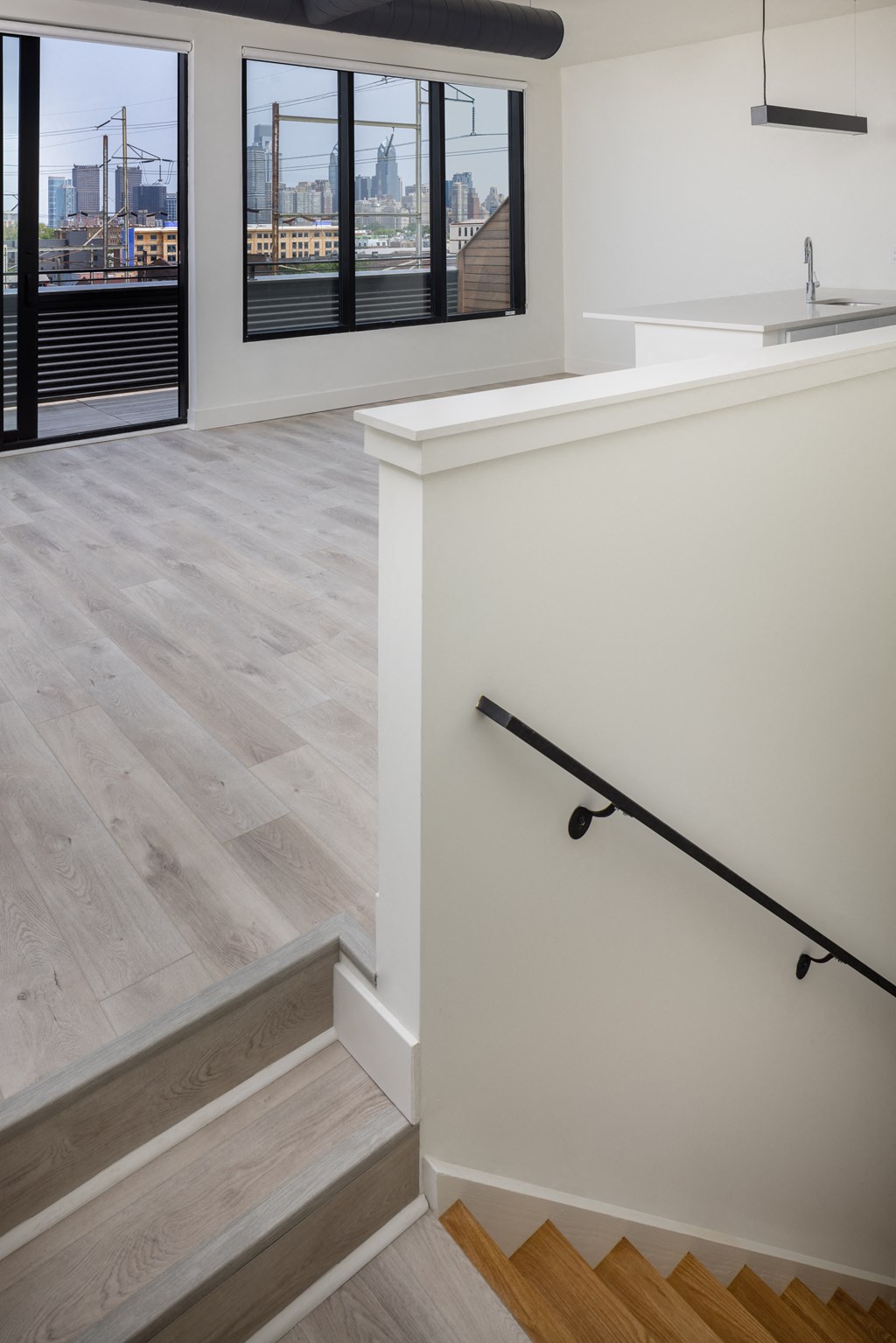 a view of the kitchen and living room from the stairs