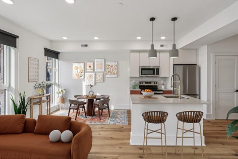 A modern kitchen with a dining table and chairs.