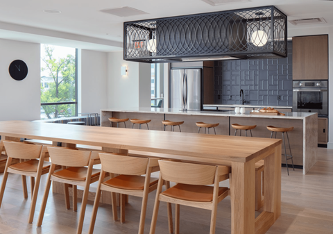 a large dining room with a wooden table and chairs