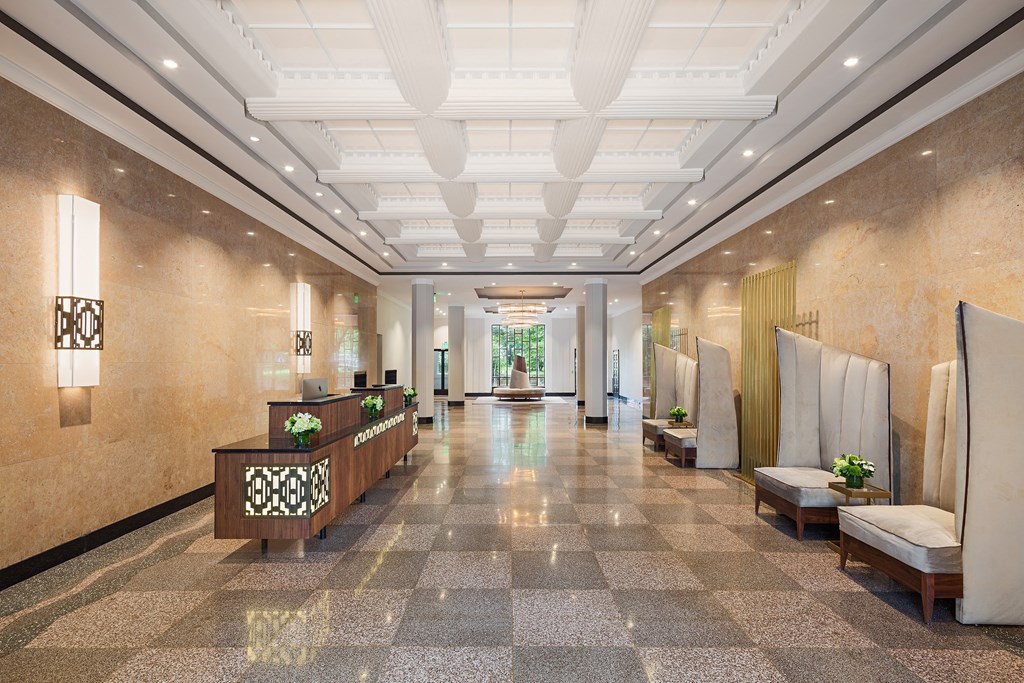 a lobby of a hotel with a reception desk