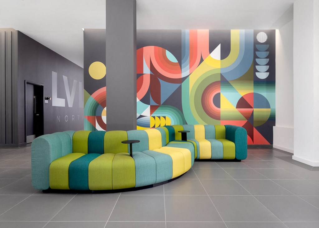 a living room with yellow and blue couches