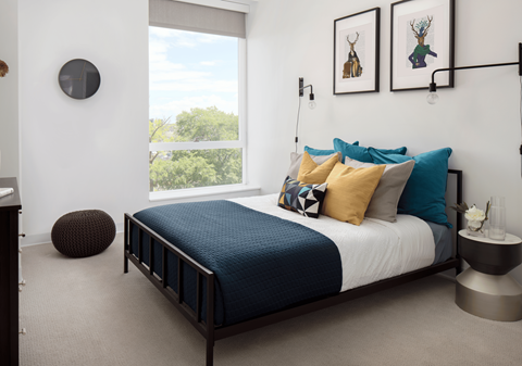 a bedroom with a bed and a large window