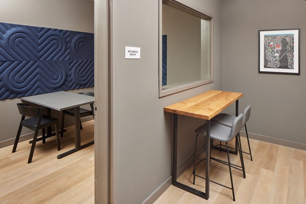 A conference room with a wooden table and chairs.