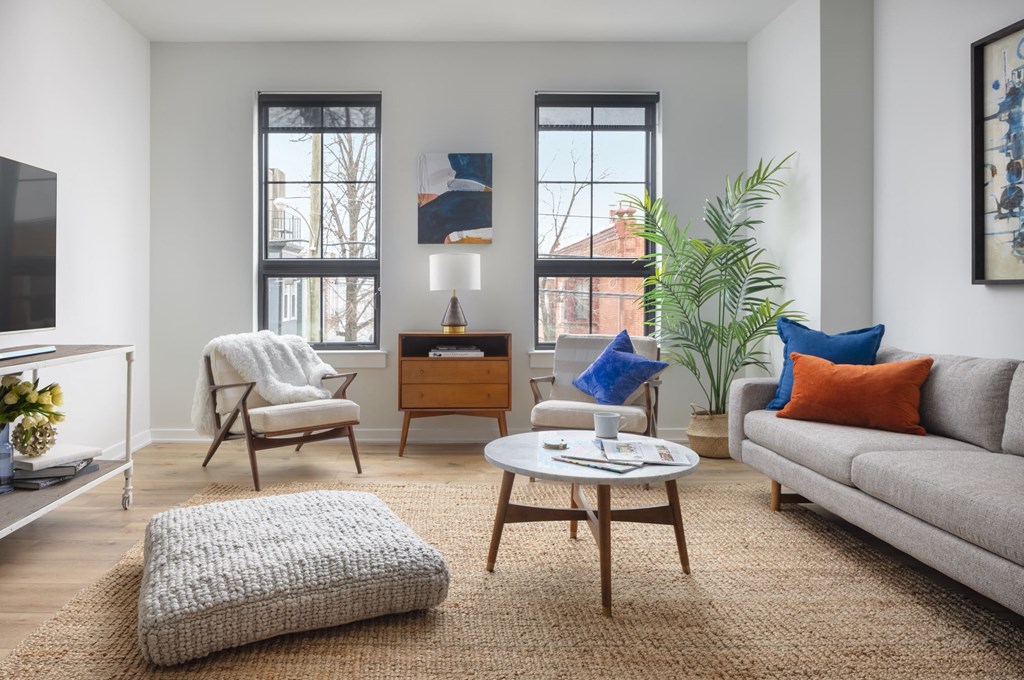 a living room with a couch and chairs and a table