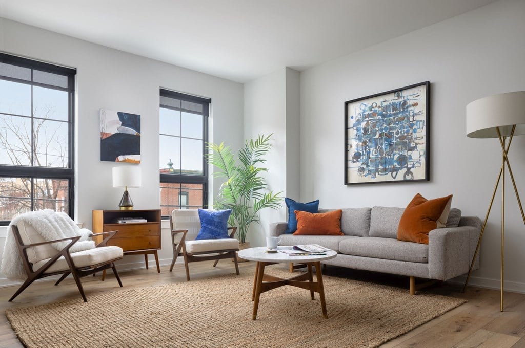 a living room with a couch and chairs and a table