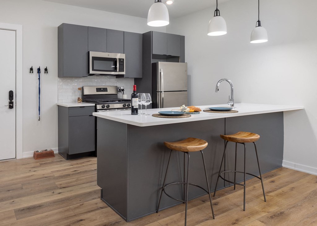 a kitchen with a center island and two stools