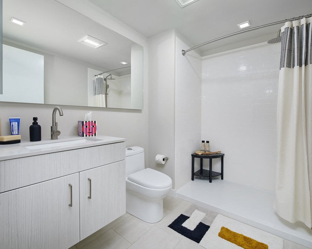 a white bathroom with a toilet and a sink