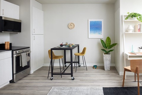 a kitchen and dining room with a table and chairs