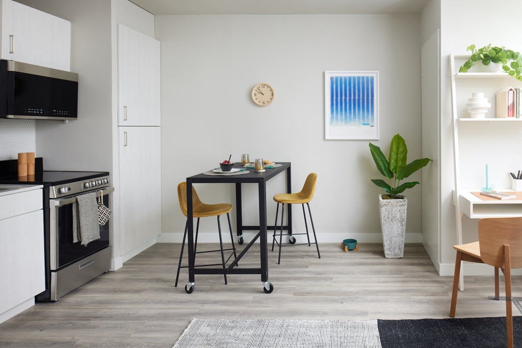 a kitchen and dining room with a table and chairs