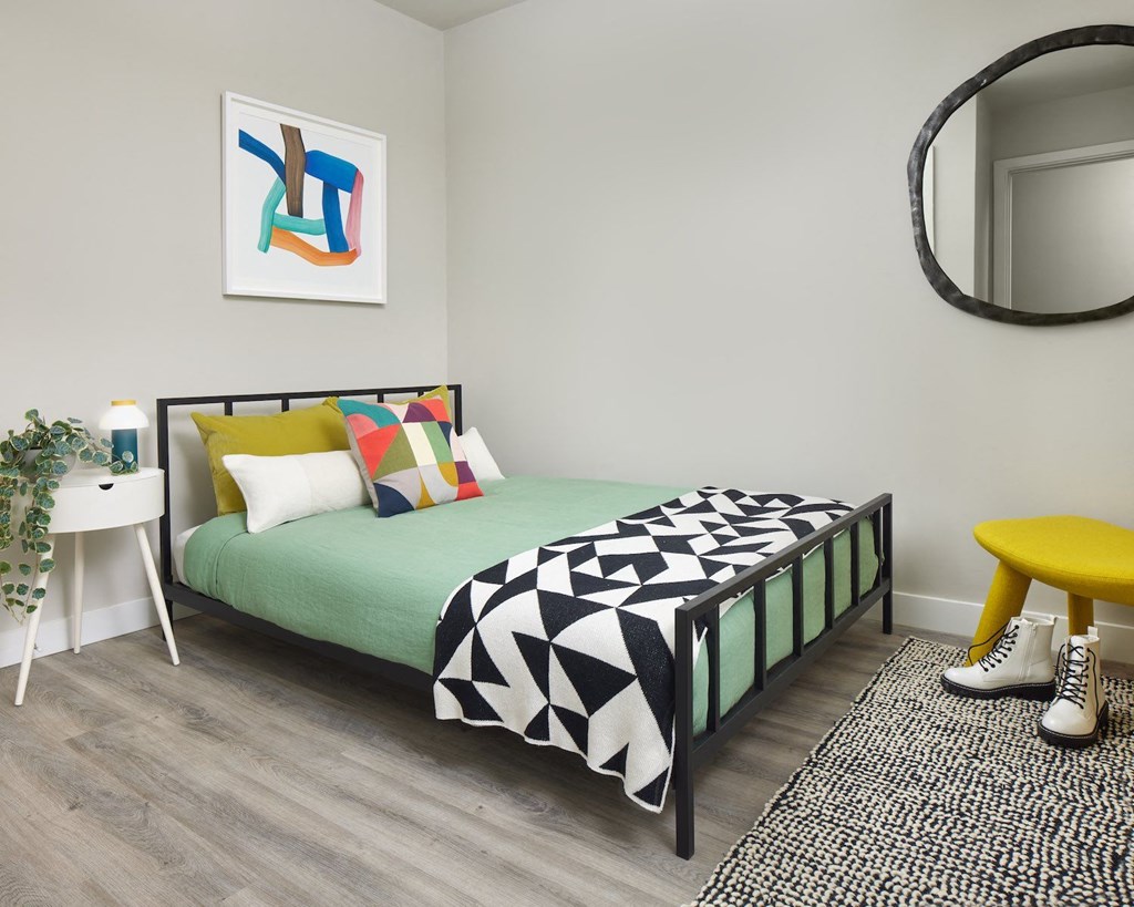 a bedroom with a bed and a mirror